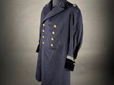 a blue coat with gold buttons on a mannequin mannequin