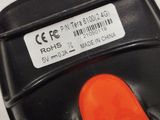 a close up of a black cell phone with an orange button