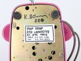 a pink toy phone with a sticker on it