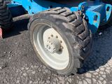 a tractor that is parked on the side of the road