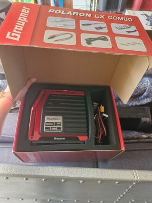 someone is holding a box that has a box with a charger inside of it
