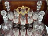 a wooden case with a lot of glassware on it
