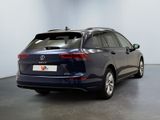 the back of a blue vw passat parked in a garage