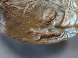 a close up of a bronze plate with a man and a child on it