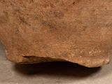 a brown vase that is sitting on the floor