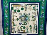 a blue and green scarf hanging on a wall next to a door