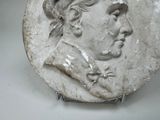 a white plate with a picture of a man on it