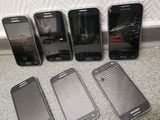 five different samsung phones are lined up next to each other on the floor