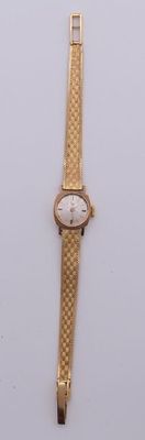 an image of a gold wrist watch on a white surface