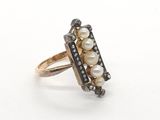 an image of a close up of a ring with pearls on it