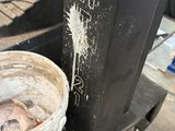 a bucket with a fish inside of it sitting on a cart