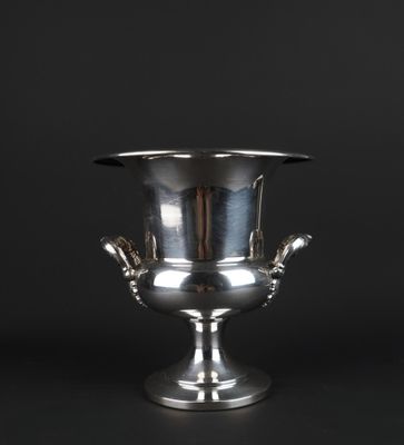 a silver vase with two hands on the base