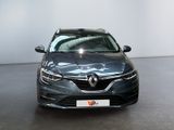 the front view of a grey car parked in a showroom