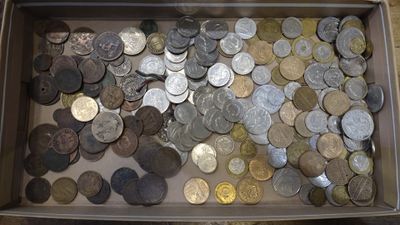 a lot of coins in a box on the table