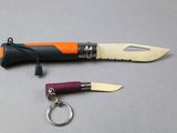 a knife and a keychain sitting next to each other
