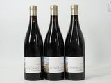 three bottles of wine sitting on top of a white table