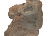 a stone sculpture of a man sitting on a rock