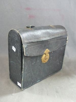 an old suitcase sitting on the floor with a tag on it