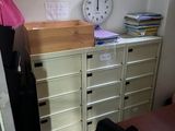 a desk with a clock on top of it in a room