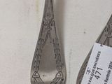 two spoons that are sitting next to each other on a table