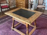 a table with a chalk board on it in the middle of a room