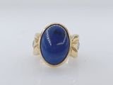 a gold ring with a blue stone in the center