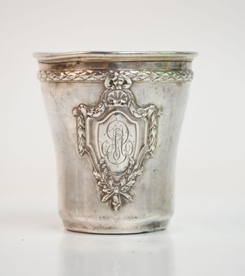 an antique silver cup with a monogram on the side