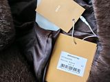 a fur coat with a tag on it and a tag attached to it
