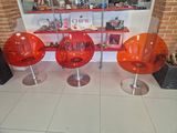 three chairs that are sitting in front of a window