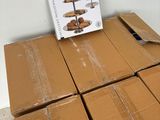 a cardboard box with a cake stand on top of it