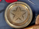 a gold plate with a star on it next to a pair of scissors and a pair of scissors