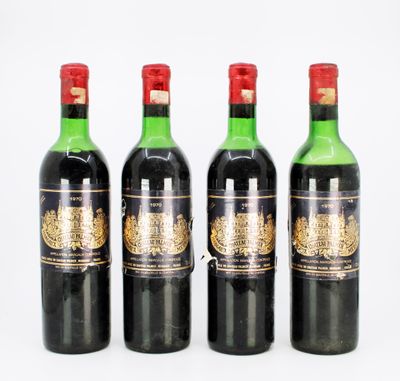 four bottles of wine are lined up on a white surface