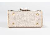 a white crocodile skin purse with a metal clasp