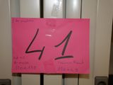 a pink sign with the number 14 on it in front of a door