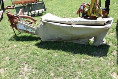 a boat that is sitting on the grass in the field