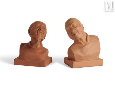 pair of clay busts of old man and woman on white background