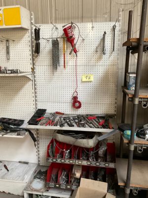 a workbench in a garage with many tools on it