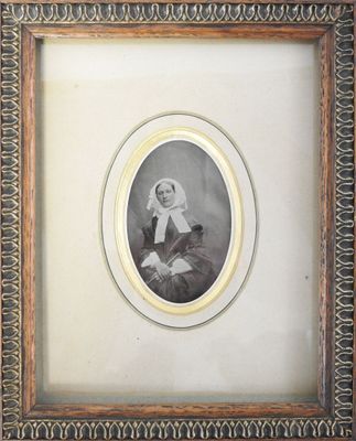 an old picture of a woman in a white dress and a black and white picture of a man