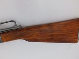 an old gun with a wooden handle on a white background