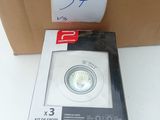 packaging of a white light sitting on top of a cardboard box