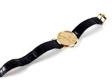 an image of a black and gold watch on a white surface