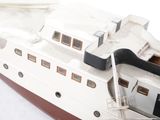 a small model of a boat on a white surface