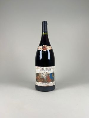 a bottle of wine sitting on top of a white table