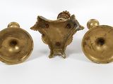 pair of antique brass candlesticks on a white background