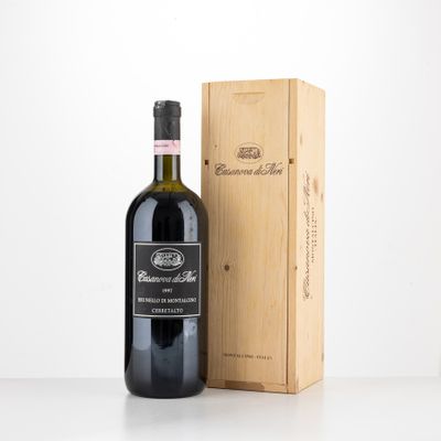 a bottle of wine sitting next to a wooden box