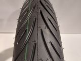 a close up of a motorcycle tire on a white surface