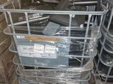 a pile of metal items in a room with a lot of boxes on the floor