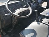 a red truck with a steering wheel and a black seat
