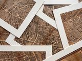 many pictures of a map on a table