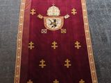 a red carpet with gold crosses and a cross on it